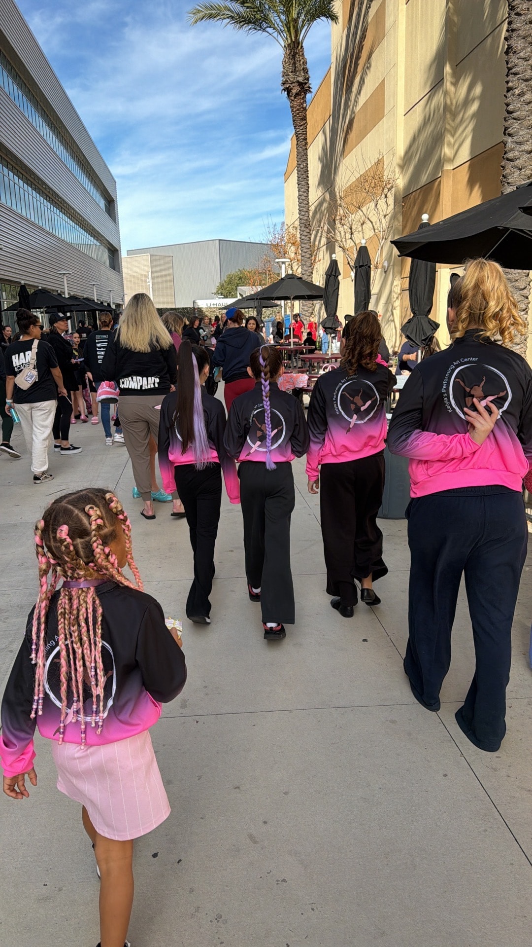 KPAC competition team walking in their matching pink and black jackets