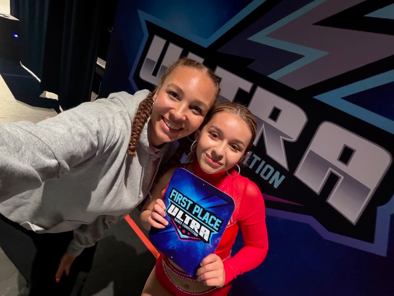 Instructor and dancer celebrating First Place at Ultra Dance Competition