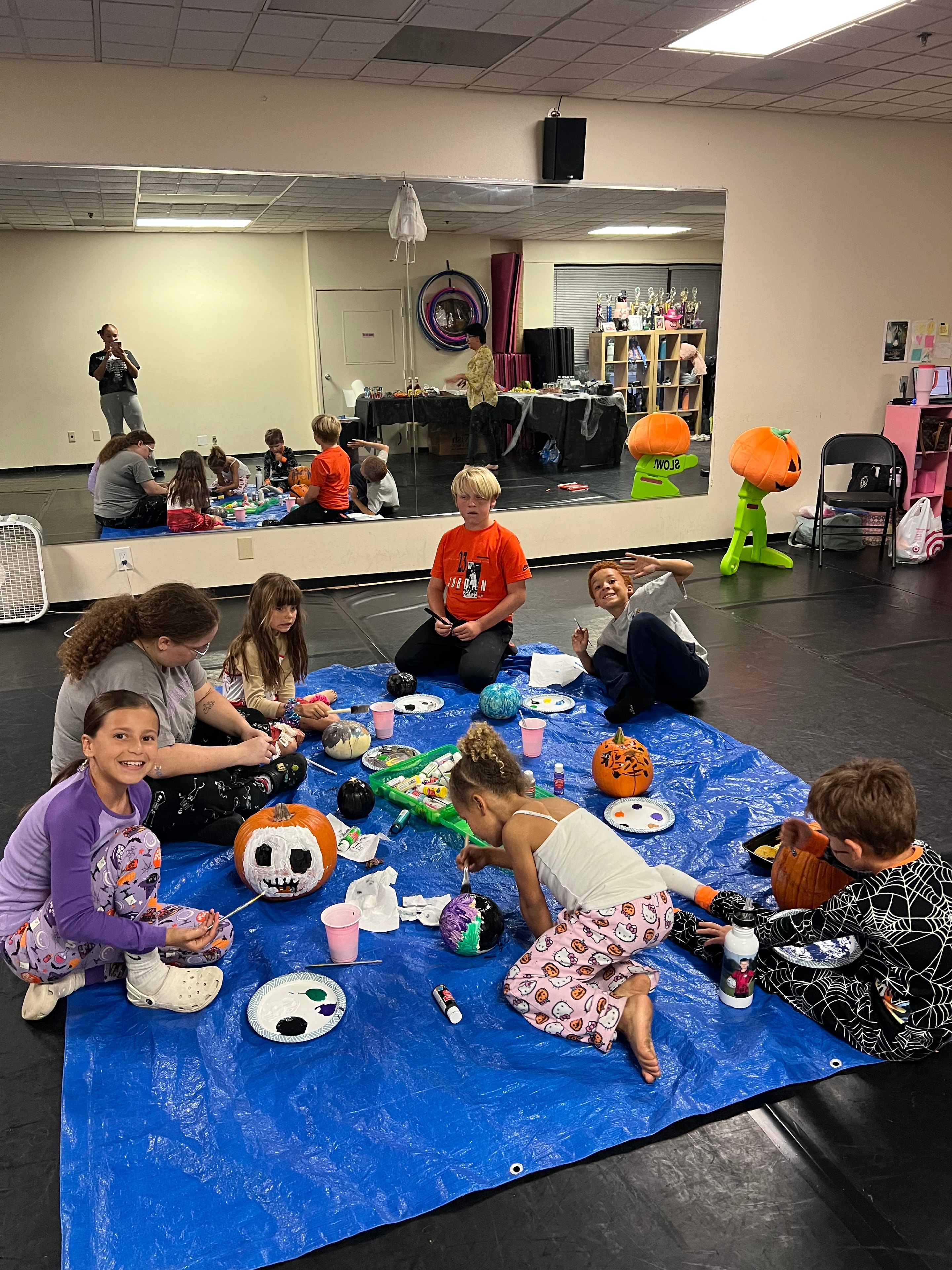 Kids painting pumpkins at KPAC Halloween event