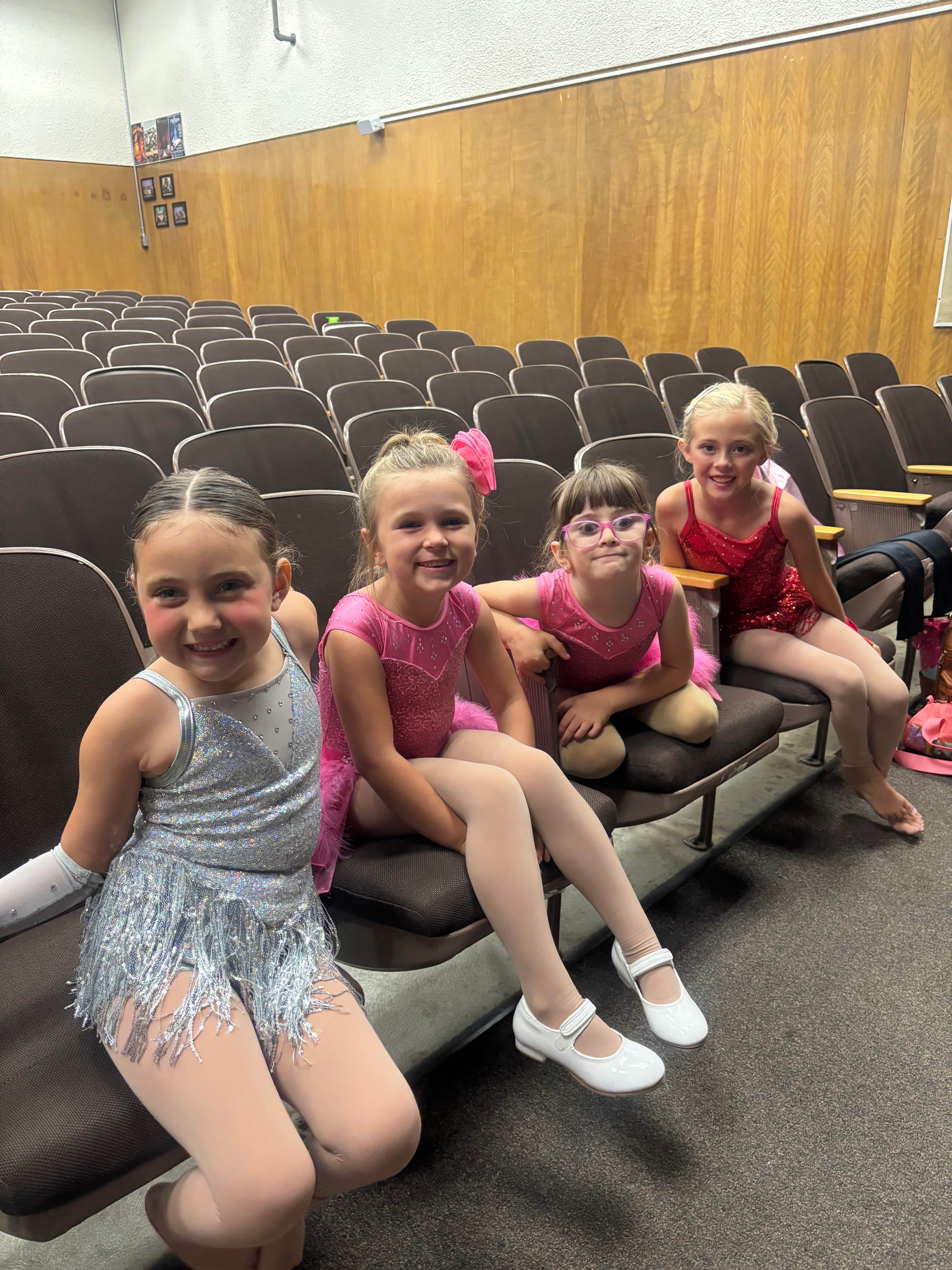 Young dancers in colorful costumes at recital