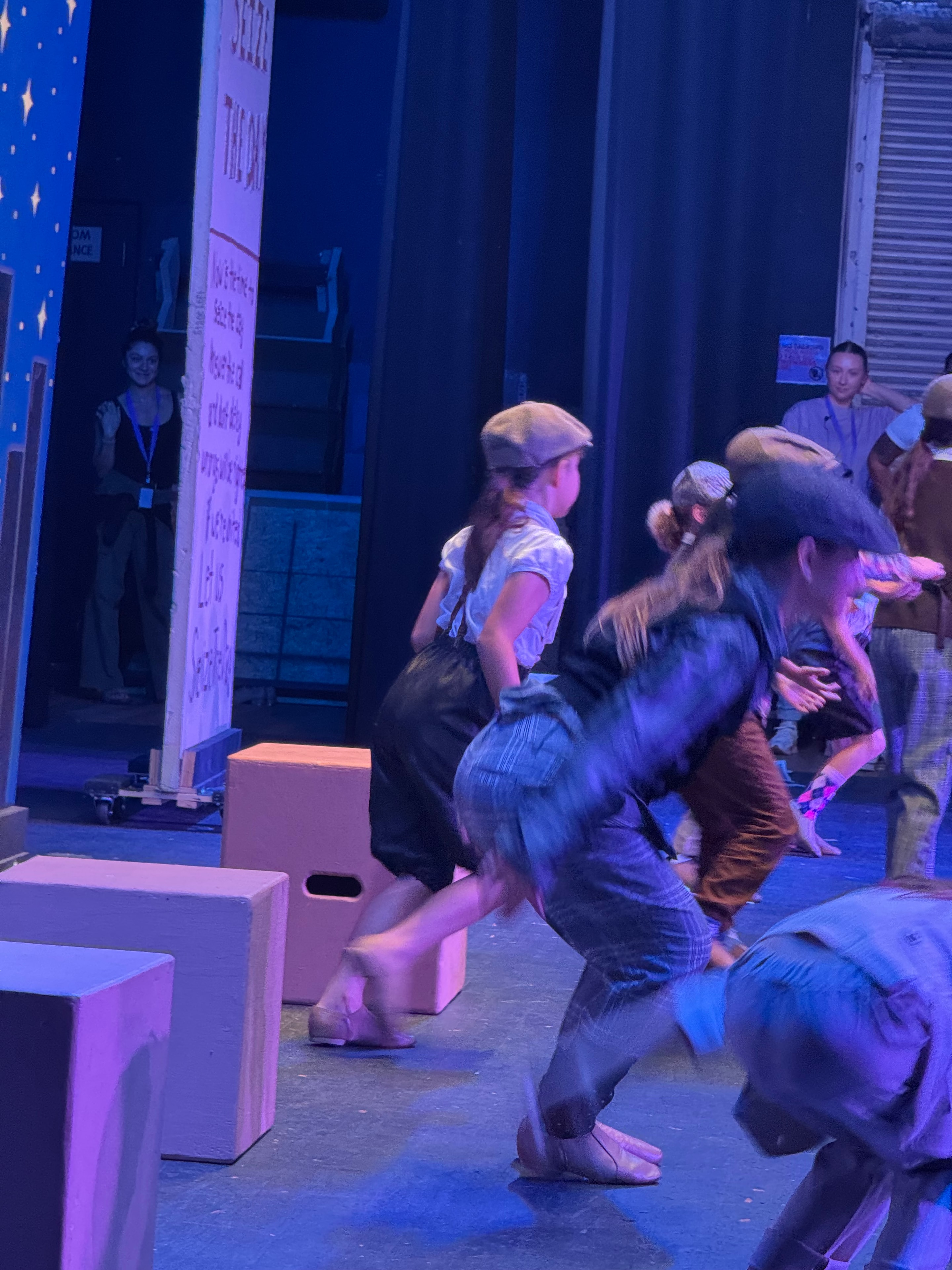 Newsies cast dancing on stage