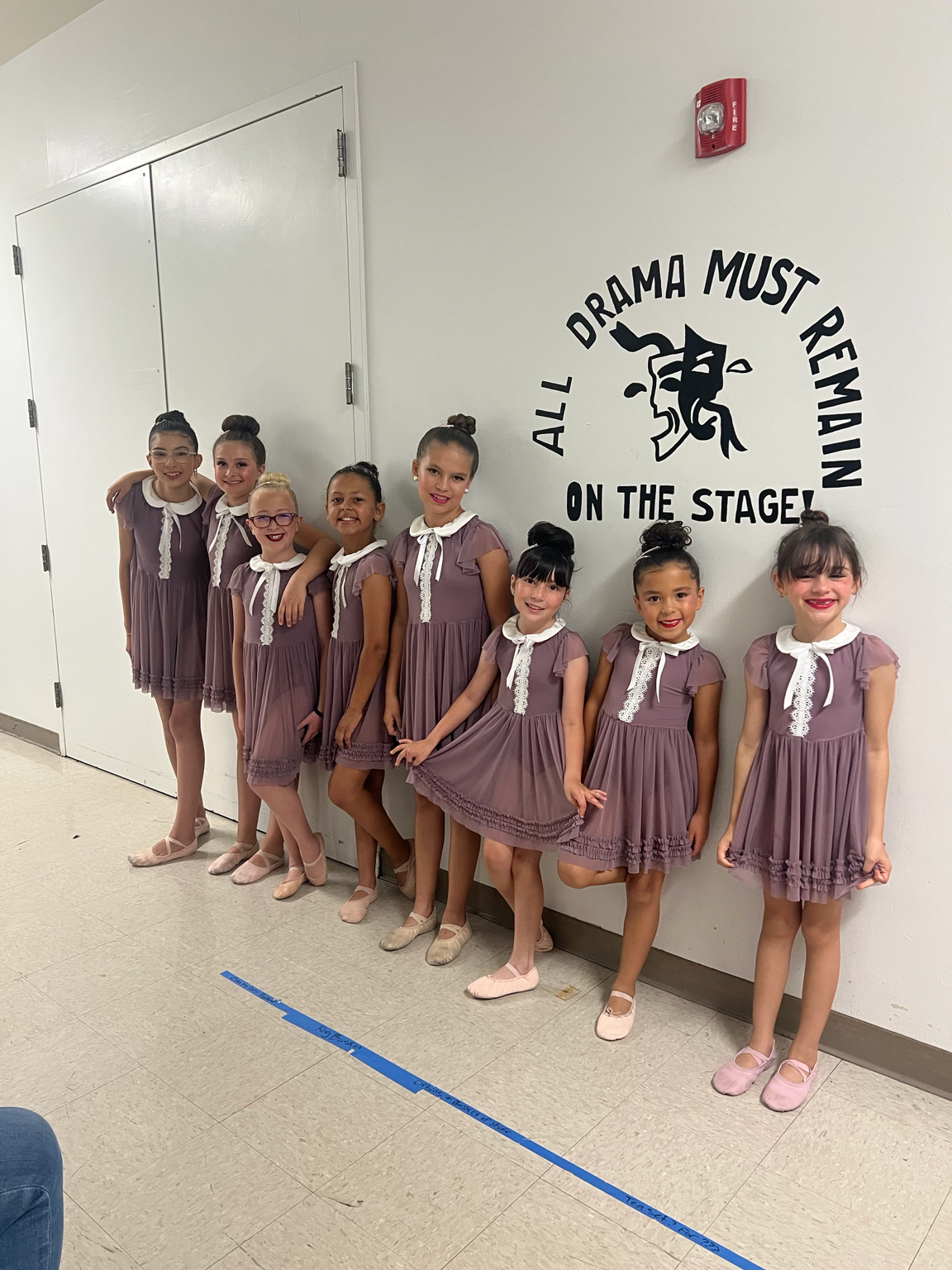 Dancers in purple dresses backstage